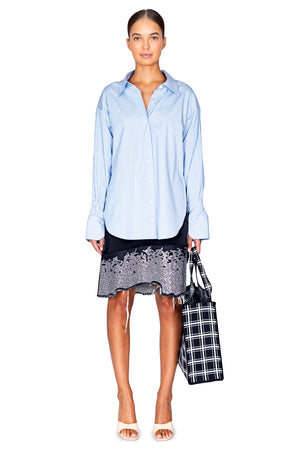 Model facing the camera in the knee length distressed glitter hem skirt