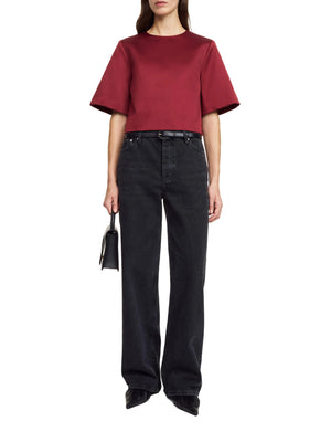 Person wearing a red top and black pants on a white background