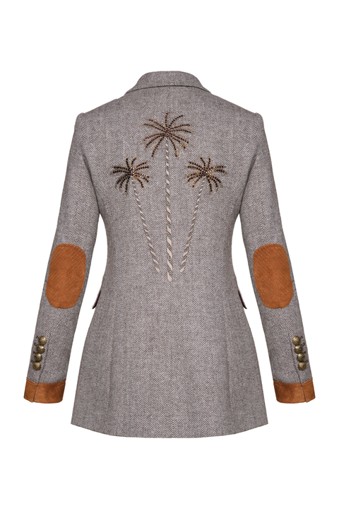 A gray herringbone blazer shown from the back, featuring embroidered palm tree motifs on the upper back, brown suede elbow patches, and brown cuff trims with gold-tone buttons.