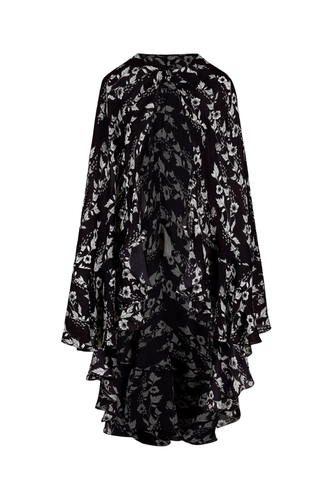 A black and white floral print long-sleeve cape top with a high-low ruffled hem, displayed on a clean white background.