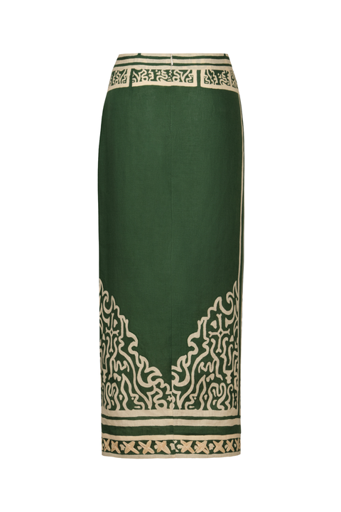 A dark green pencil skirt featuring intricate beige and black printed patterns, including a geometric border at the waist and a stylized wave design near the hem.