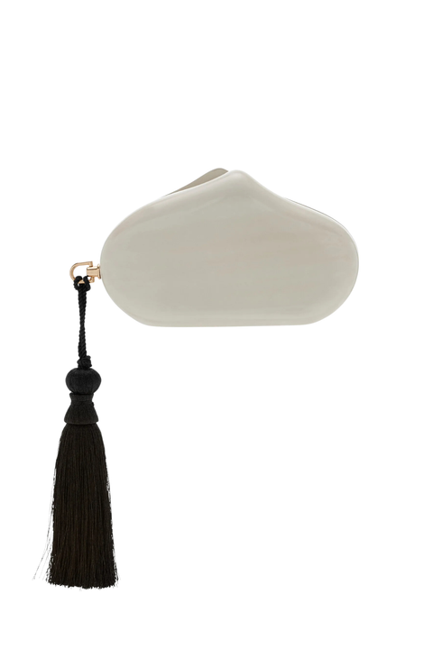 White clutch with magnetic closure and black tassel