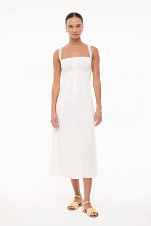 Woman wearing a white dress on a white background