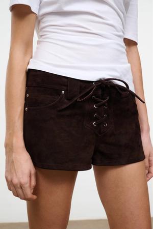 Brown lace-up shorts worn with a white t-shirt on a plain background.