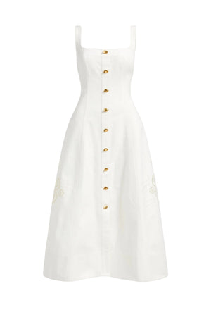 White dress with gold buttons on a light gray background