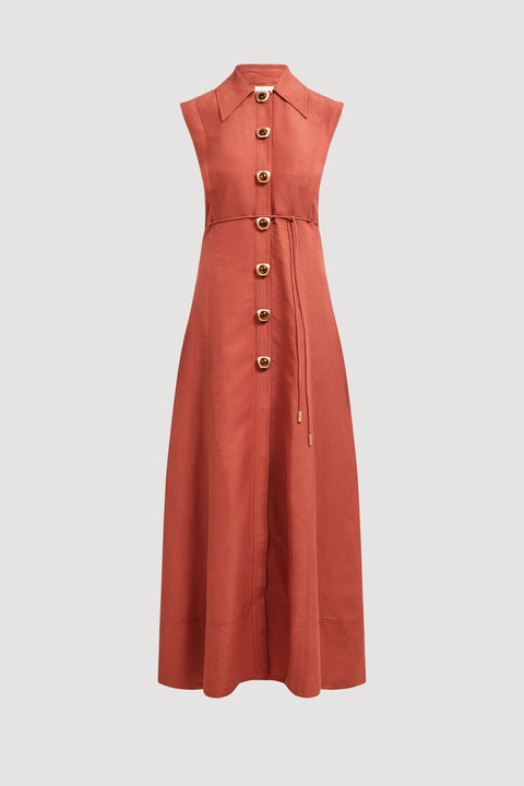 Flat lay of long rust-colored collared dress with button details on a light gray background