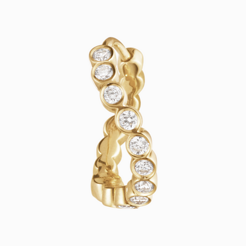 Gold earring with embedded diamonds on a white background