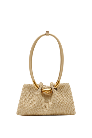 Woven handbag with gold handle on a white background