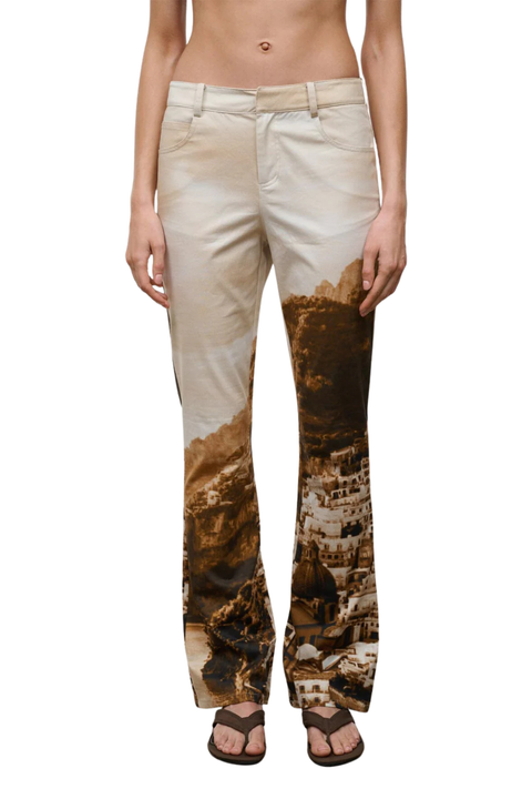woman wearing cliffside patterned beige and brown pants on a white background close up
