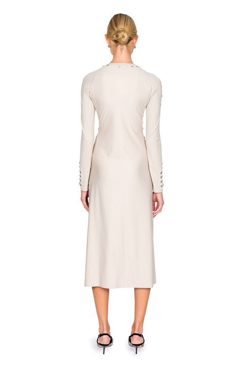 Back of woman wearing a beige midi dress with long sleeves on a white background