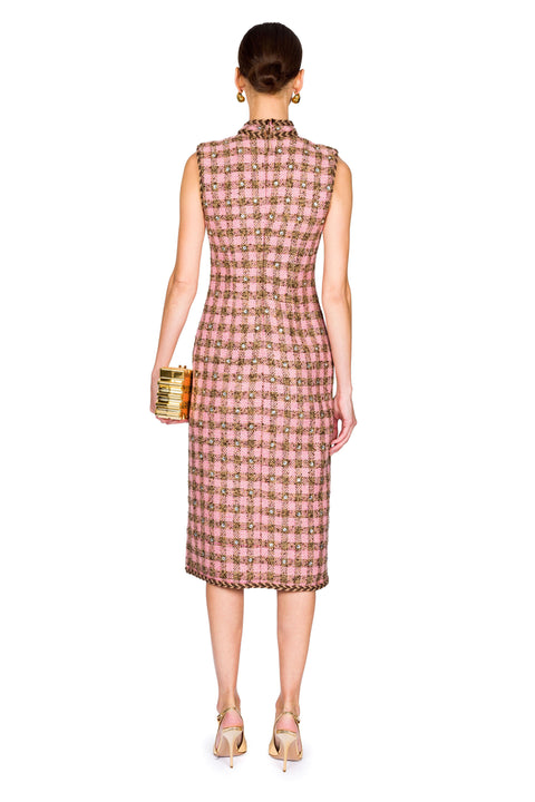 Back of woman wearing a sleeveless checkered dress on a white background