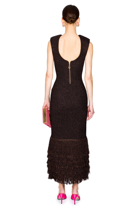 Woman facing away wearing a brown maxi dress with a zipper back on a white background