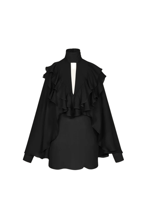 A black long-sleeve blouse with a high mock neck, dramatic cascading ruffles across the shoulders and chest, and a split V-back opening, against a plain white background.