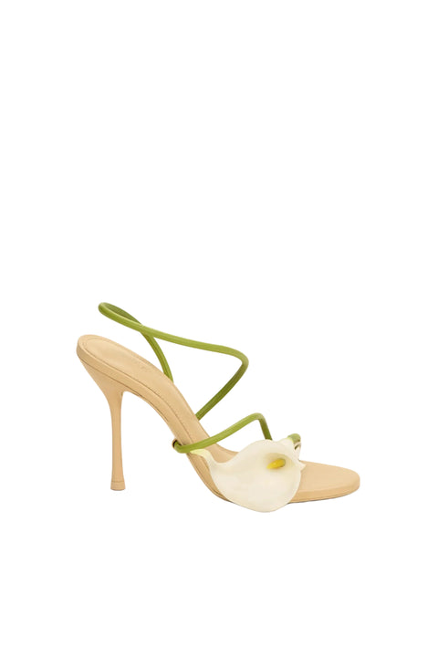 High-heeled shoe with lily and green strap on a white background