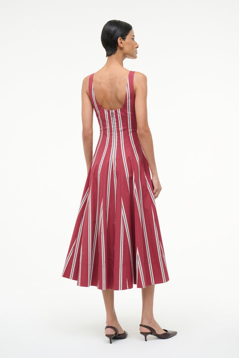 Woman wearing a red and white striped dress on a white background