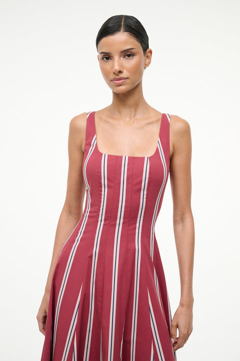 Woman wearing a red and white striped dress on a white background
