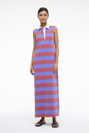Woman wearing a sleeveless maxi dress with red and blue stripes on a white background