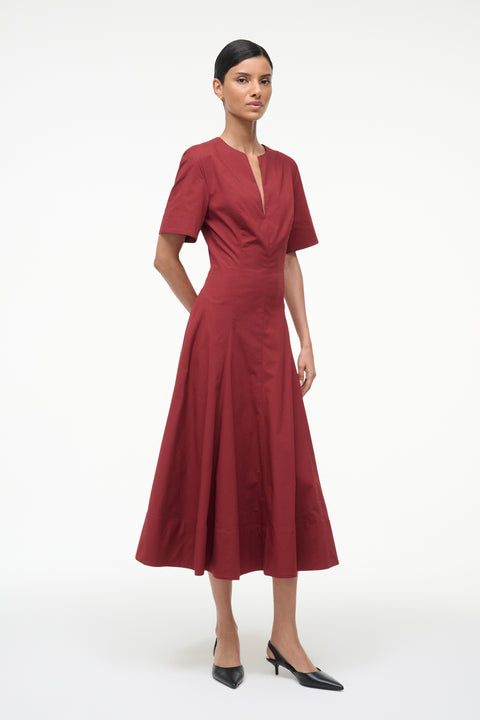 Red dress worn by a model on a white background