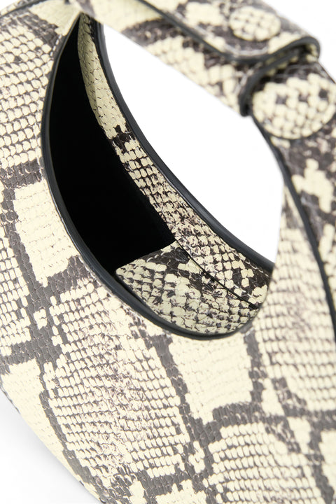 Close-up of a snake print handbag with a black interior.
