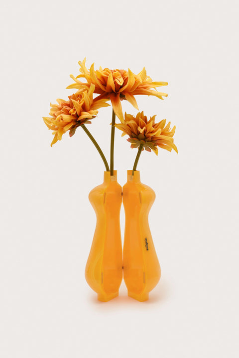 Image of opened vase clutch with yellow flowers on a white background