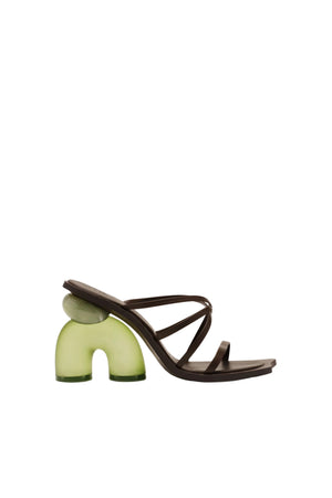 Heeled sandal with green translucent sole and brown straps on a white background