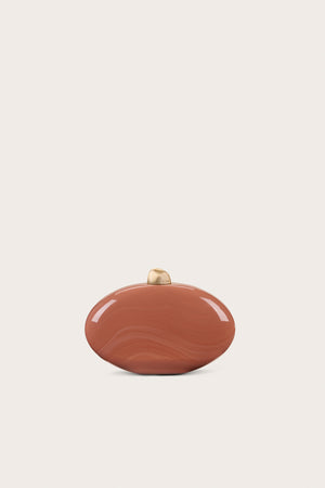 A burnt orange oval-shaped, marbled acrylic clutch that features gold-toned hardware on the top.