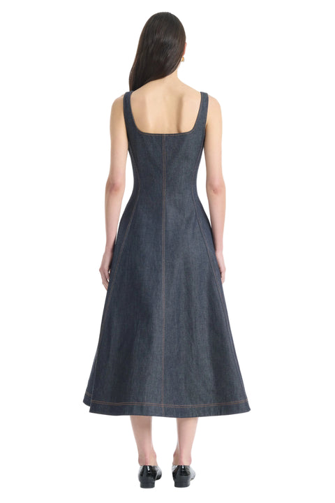 Woman facing away showing back of dark denim midi dress on a white background