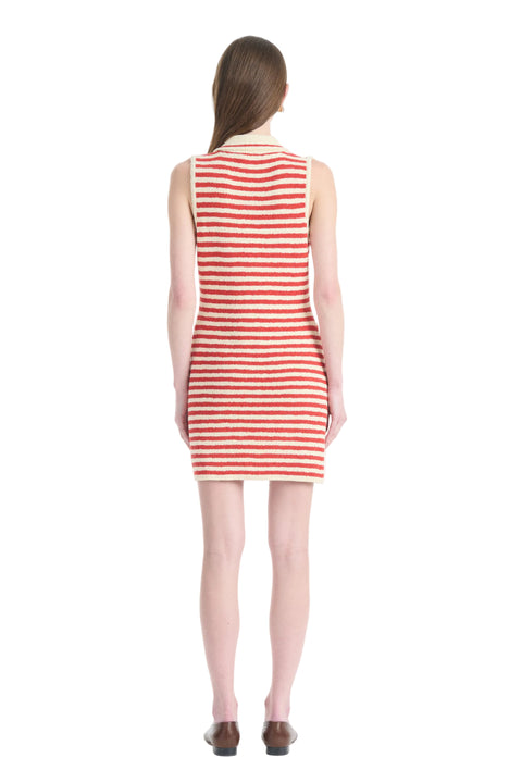 Back of woman in red and white striped mini dress and brown shoes.