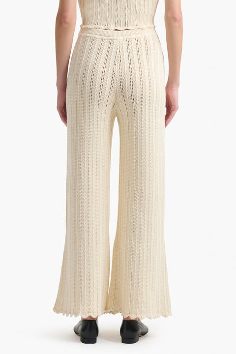 Back of the cream knitted wide leg pants on woman.