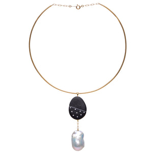 A gold neck wire necklace that features a pendant with a large abstract pearl dangling from a black stone embellished by small round diamonds.