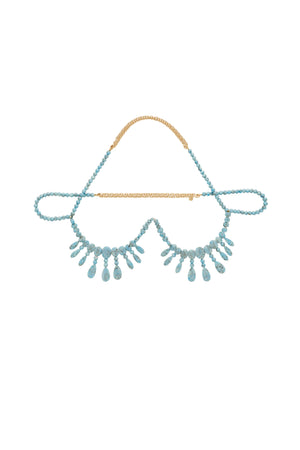 Beaded necklace bralette with a blue and gold design on a light gray background
