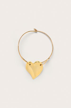 A gold-toned choker that features a large abstract heart pendant fixed on a neck wire with a hook clasp.