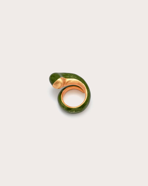 Green and gold ring on a light gray background