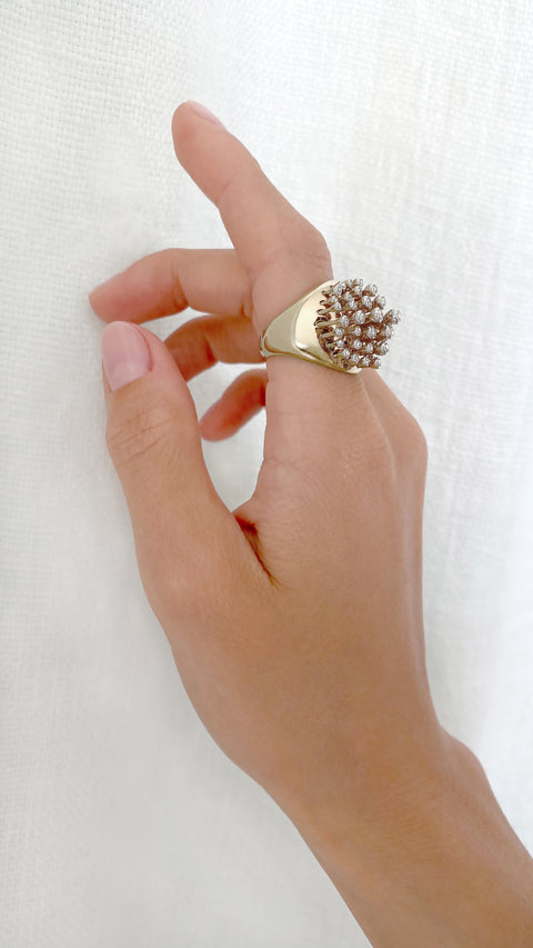 Hand modeling large yellow gold ring with petruding bezel set diamond detail.