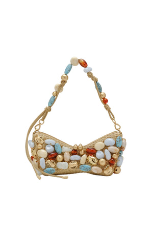 Gold handbag with colorful beads on a beige background
