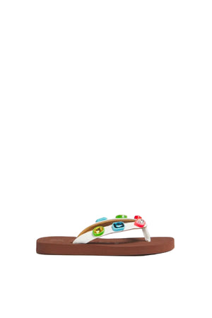 Brown rubber flip-flop sandal with white straps and colorful decorations on a light gray background