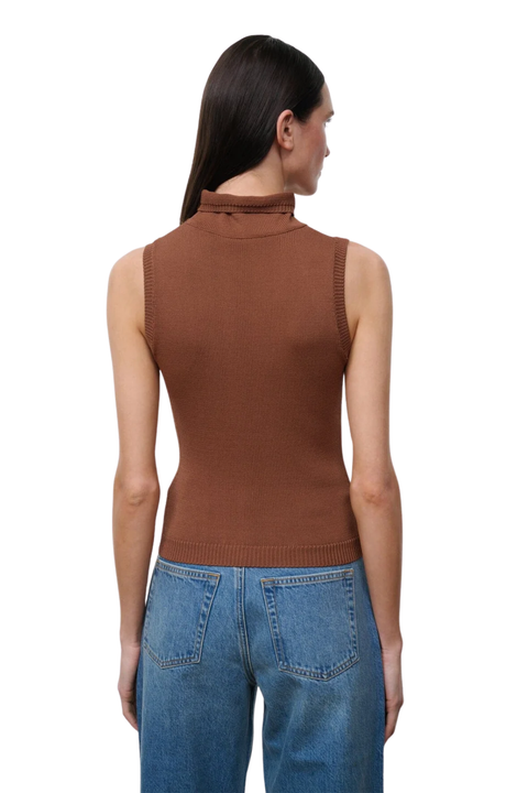 A woman shown from the back wearing a sleeveless ribbed mock neck top in a warm brown color, paired with blue jeans, against a plain white background.