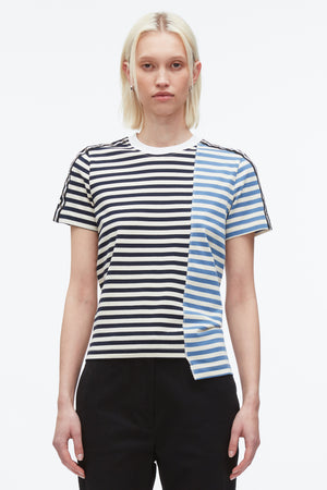 Up close of woman in patchwork striped t-short with ribbed neckline and asymmetric hemline.