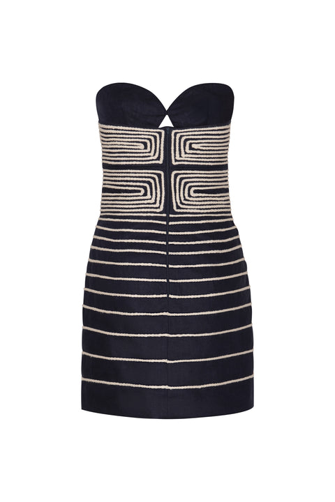 Back of navy strapless dress with white embroidery.