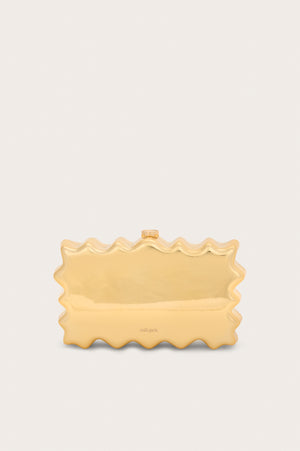 A metallic gold rectangular, acrylic clutch that features a wavy perimeter design and gold hardware.