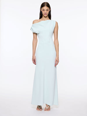 Woman wearing a light blue off-shoulder gown on a white background