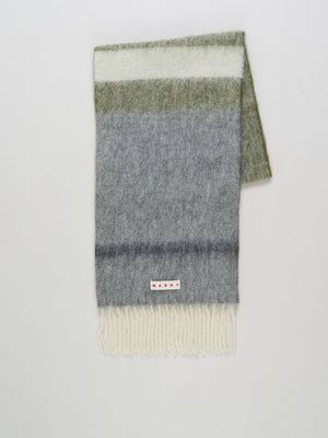 Multicolored striped scarf with a visible brand label on a light gray background