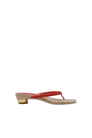 Sandal with a red thin strap on a white background