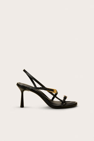 Side profile of a black heel that features two over the foot straps with gold-toned buckle details and an ankle strap.