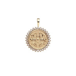 Gold coin pendant that features two twin bees surrounded by a ring of white topaz stones.