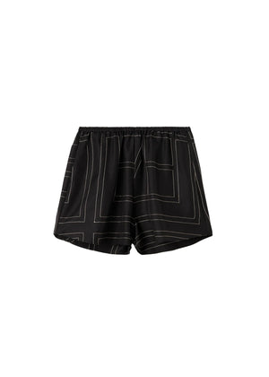 Black shorts with white geometric lines on a light gray background