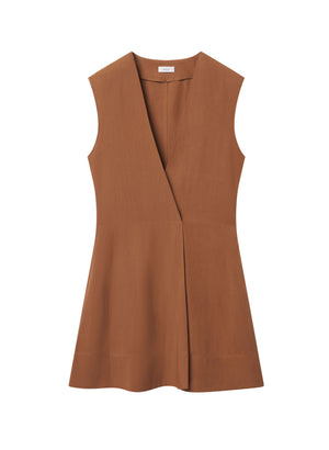 Flat lay of rust mini dress with v-neck and white background