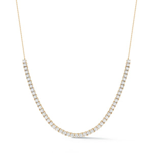 A yellow gold tennis necklace with white diamonds.
