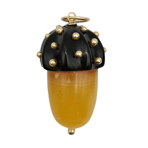 Acorn-shaped gold onyx pendant with gold accents on a white background