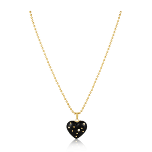 Gold necklace with a black heart-shaped pendant on a white background